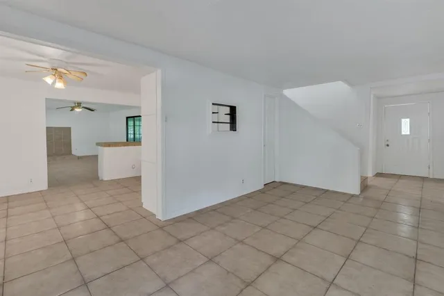 a view of a big room with closet and windows