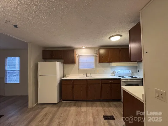 a kitchen with a sink and refrigerator
