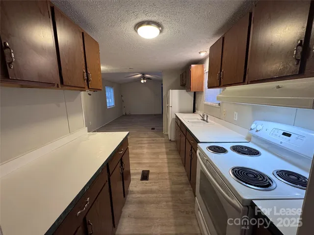 a kitchen that has a sink and a stove