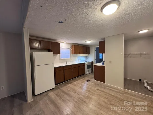 a kitchen with a refrigerator sink and cabinets
