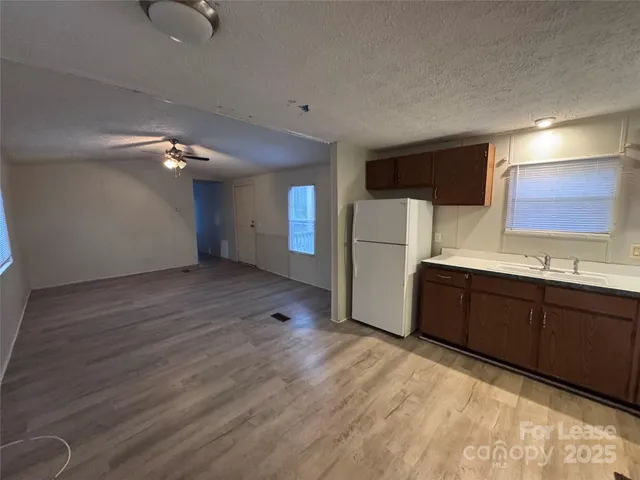 a kitchen with stainless steel appliances a refrigerator and a sink