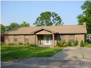 4220 Jernigan Road Pace, FL 32571 - Photo 1 of 7 a front view of a house with garden