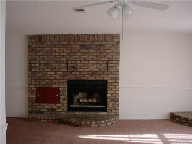 4220 Jernigan Road Pace, FL 32571 - Photo 4 of 7 a room with a fireplace