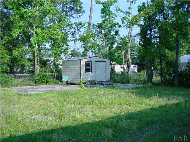 4220 Jernigan Road Pace, FL 32571 - Photo 5 of 7 a view of backyard of house with green space