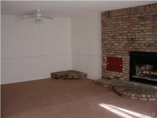 4220 Jernigan Road Pace, FL 32571 - Photo 7 of 7 a room with a fireplace