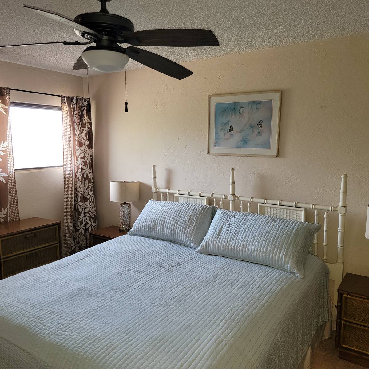 4451 Moana Road, Unit 203 Waimea, HI 96796 - Photo 3 of 6 a bedroom with a bed and a chandelier
