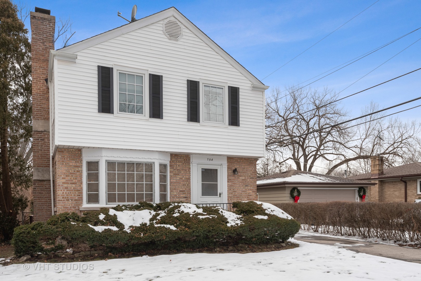 734 Beaver Road Glenview, IL 60025 - Photo 1 of 26 a front view of a house with a yard