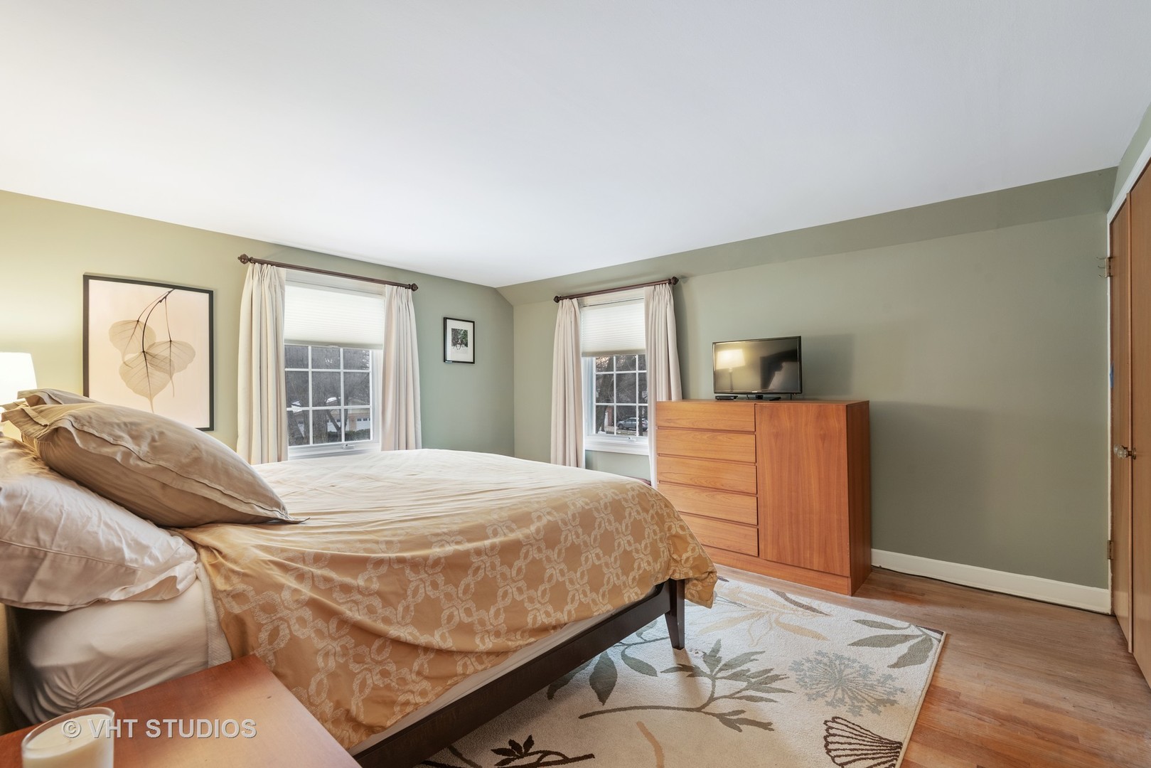 734 Beaver Road Glenview, IL 60025 - Photo 13 of 26 a bedroom with a large bed and wooden floor