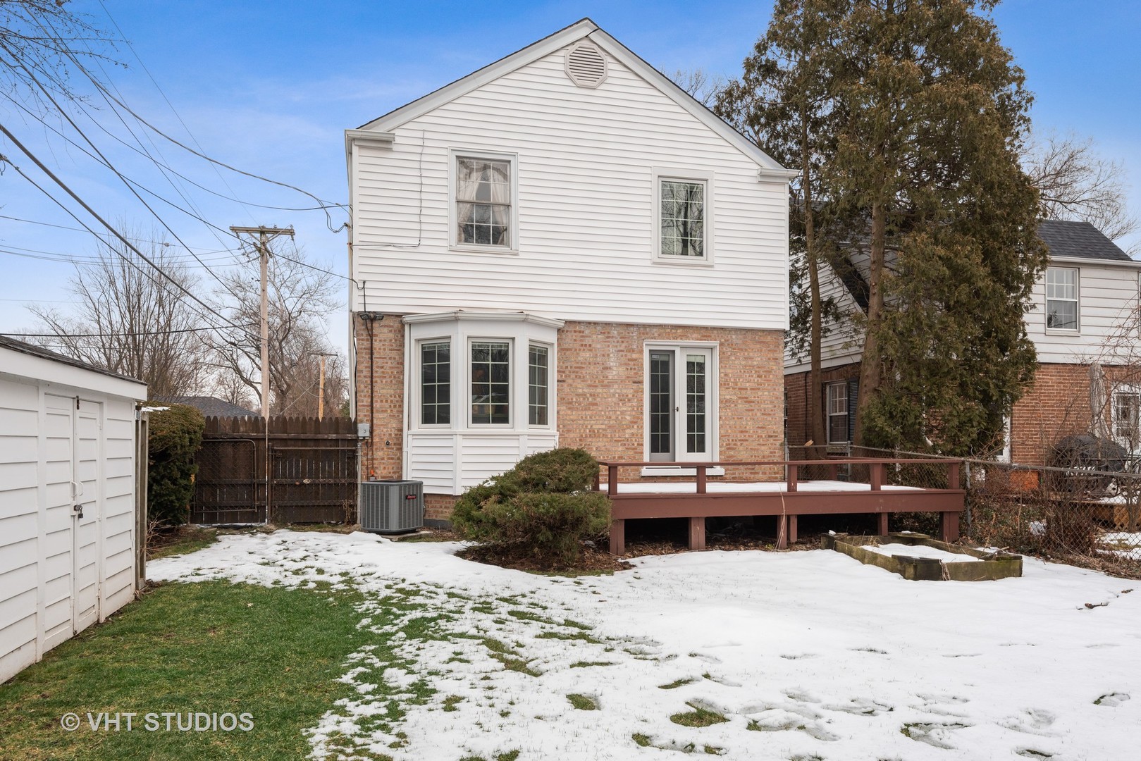 734 Beaver Road Glenview, IL 60025 - Photo 19 of 26 a front view of a house with a yard covered in snow