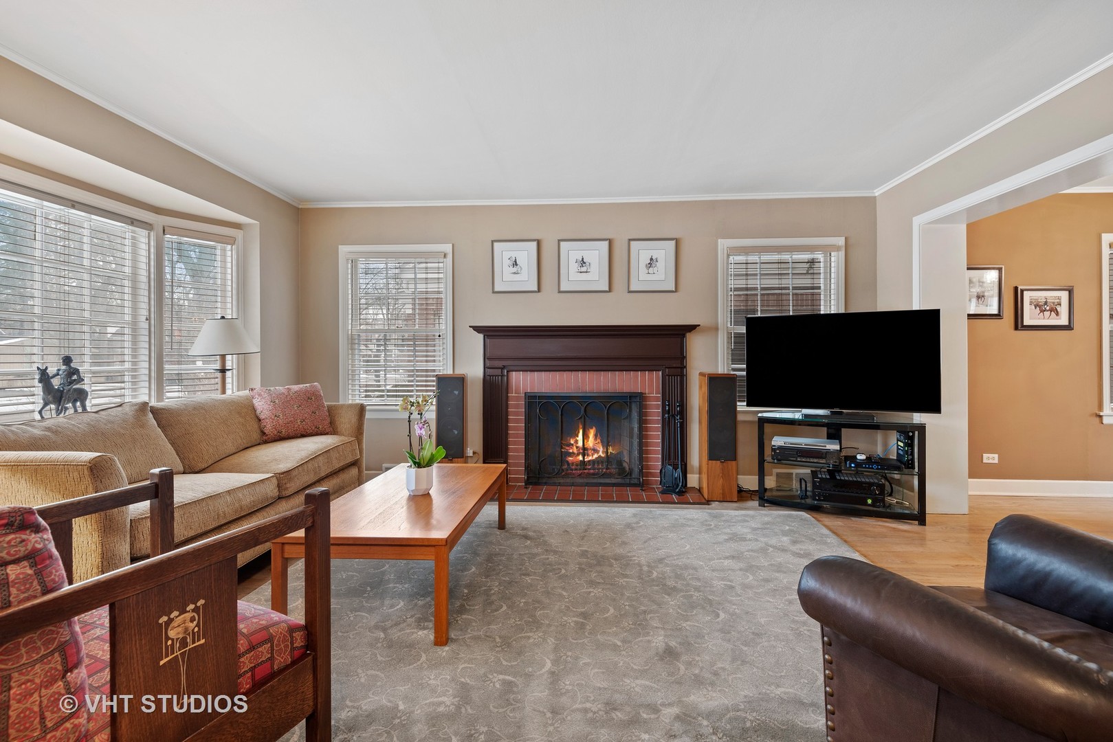 734 Beaver Road Glenview, IL 60025 - Photo 5 of 26 a living room with furniture a flat screen tv and a fireplace