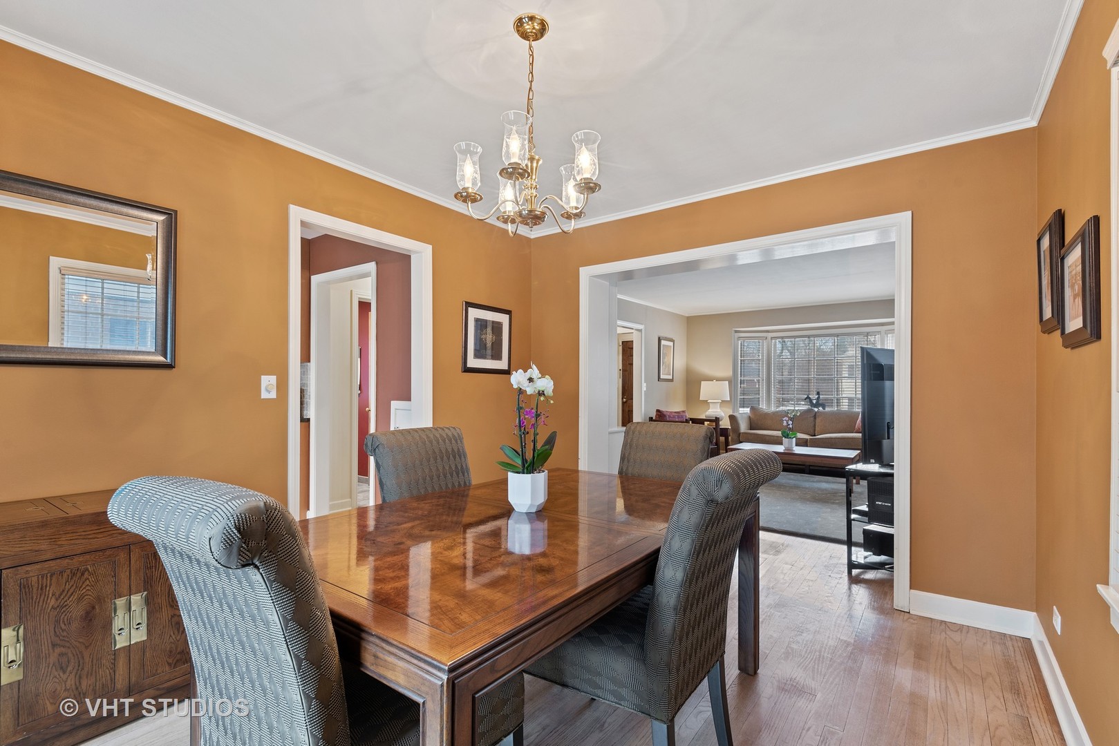 734 Beaver Road Glenview, IL 60025 - Photo 8 of 26 a dining room with furniture a chandelier and wooden floor