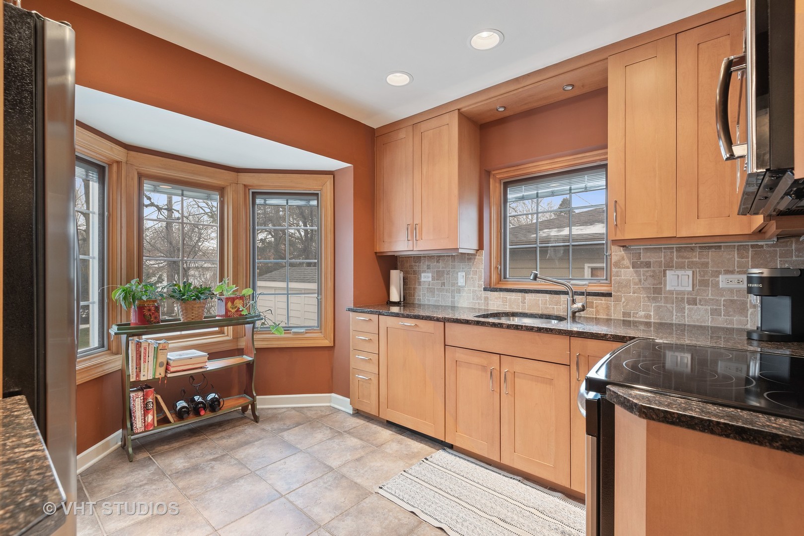 734 Beaver Road Glenview, IL 60025 - Photo 10 of 26 a kitchen with stainless steel appliances granite countertop a refrigerator a sink and wooden cabinets