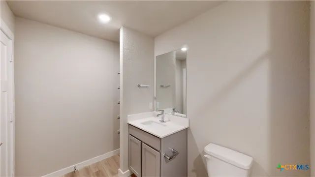 a bathroom with a sink a toilet and a mirror