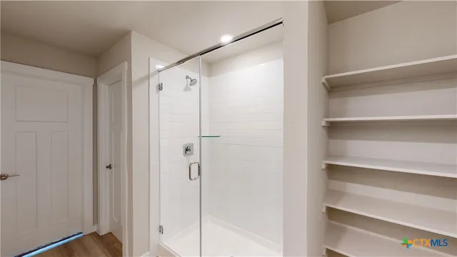 a bathroom with a glass shower door