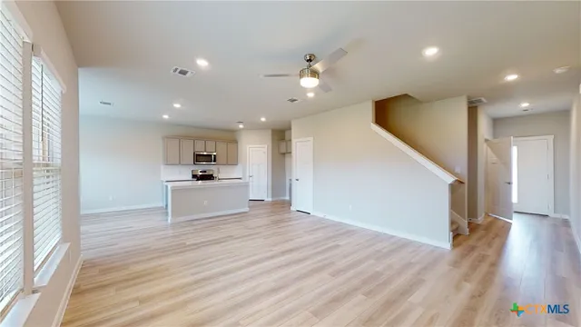 a view of a kitchen with wooden floor and a kitchen