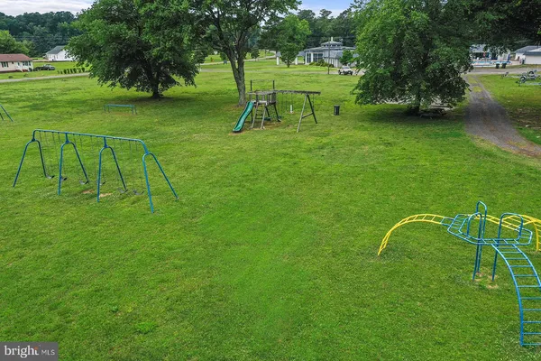 a backyard of a house with barbeque oven and outdoor seating