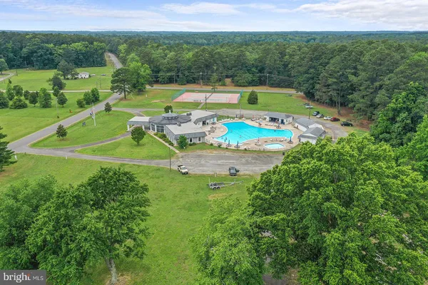 a view of a house with a yard and sitting area