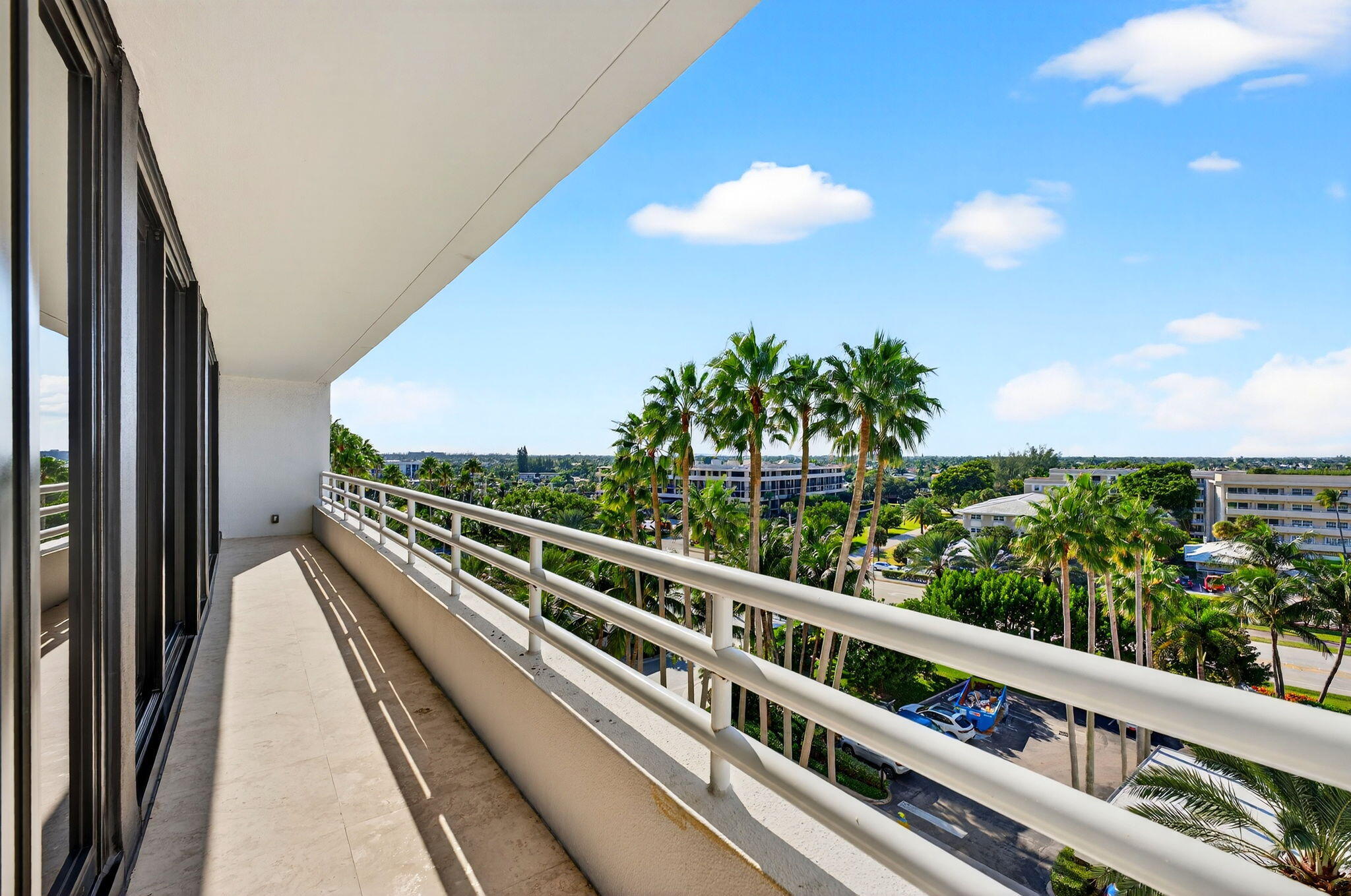 1400 South Ocean Boulevard, Unit 605 Boca Raton, FL 33432 - Photo 40 of 77 a view of a balcony with wooden floor and fence