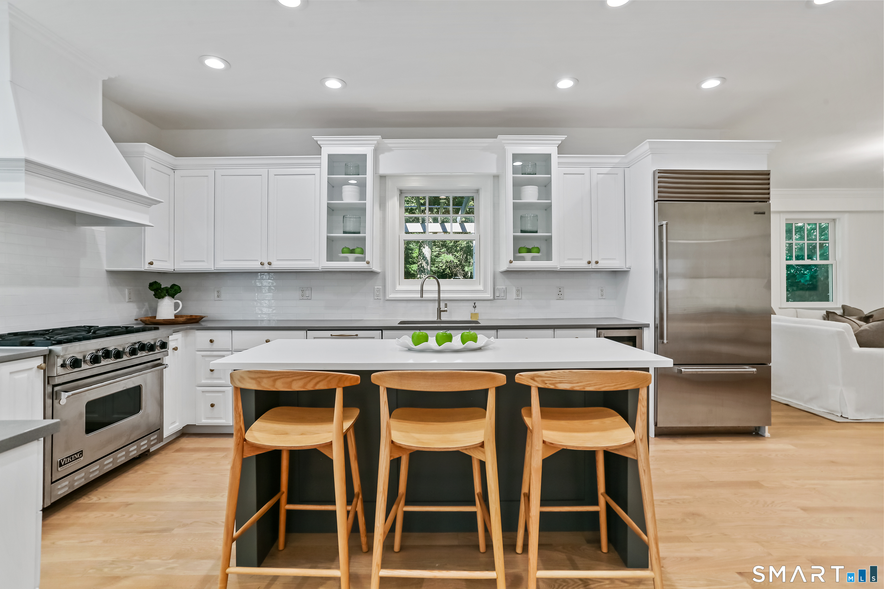 21 Woods Grove Road Westport, CT 06880 - Photo 10 of 38 Recently refreshed with new quartz counters with breakfast bar in the island.