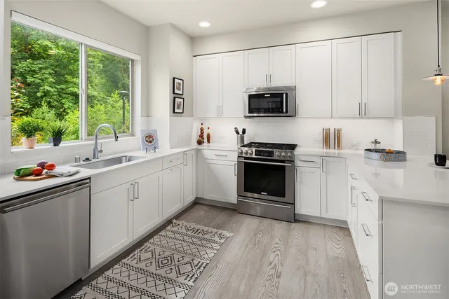 a kitchen with a sink stove and microwave