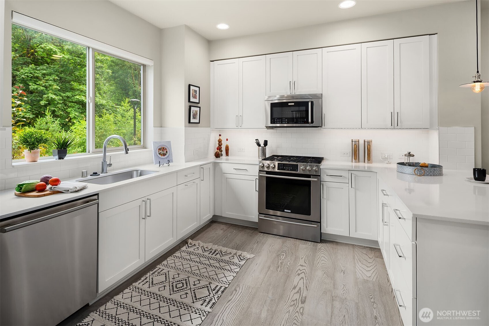 1910 Riva Lane Northwest Issaquah, WA 98027 - Photo 11 of 31 a kitchen with a sink stove and microwave