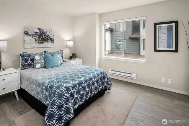 a bedroom with a large bed and a window