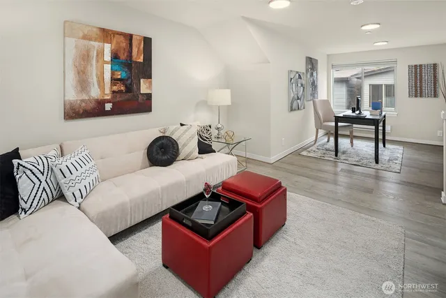 a living room with furniture and a wooden floor