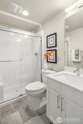 a bathroom with a toilet sink and shower