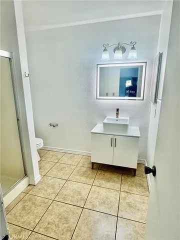 a bathroom with a sink a mirror and a shower