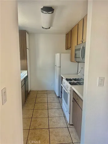 a kitchen with granite countertop a stove and a refrigerator