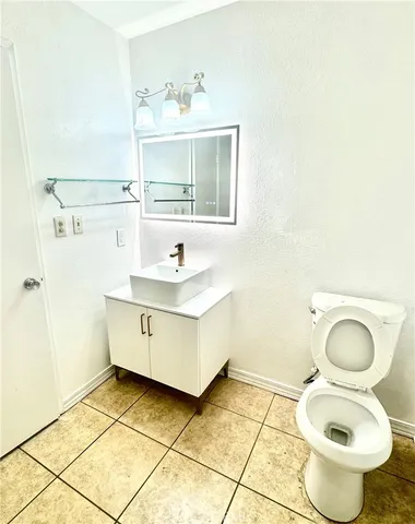 a bathroom with a sink toilet and mirror