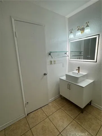 a bathroom with a sink vanity and mirror