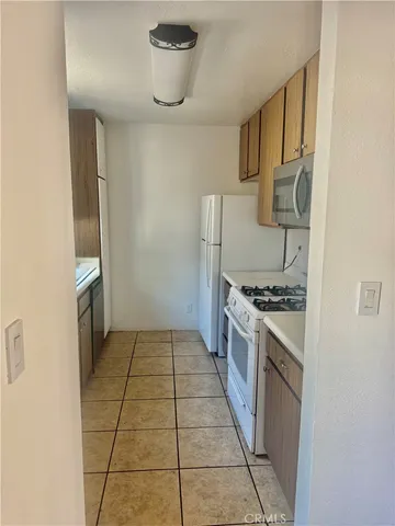 a kitchen with granite countertop a stove and a refrigerator