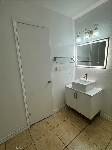 a bathroom with a sink vanity and mirror