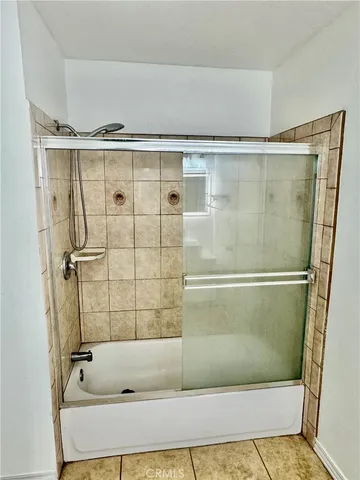 a bathroom with a shower and a tub