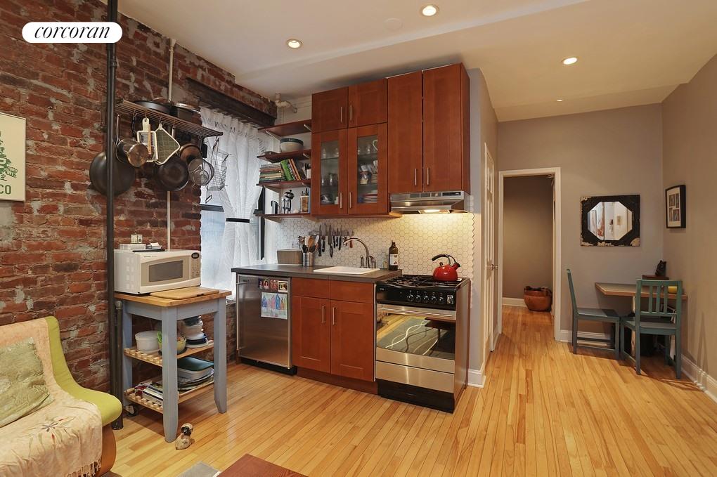 311 East 3rd Street, Unit 17 Manhattan, NY 10009 - Photo 1 of 1 a kitchen with stainless steel appliances granite countertop a stove and a wooden floors