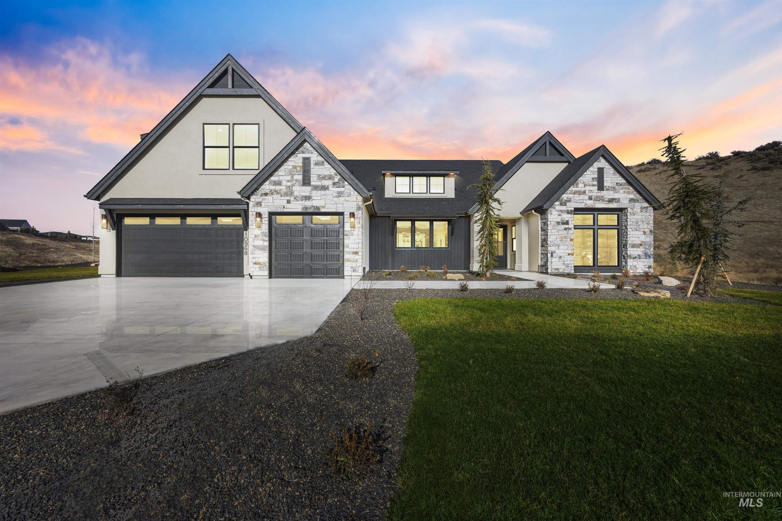 10968 North Elk Ridge Place Boise, ID 83714 - Photo 2 of 49 Modern inspired farmhouse with stone siding, a front yard, driveway, a garage, and stucco siding