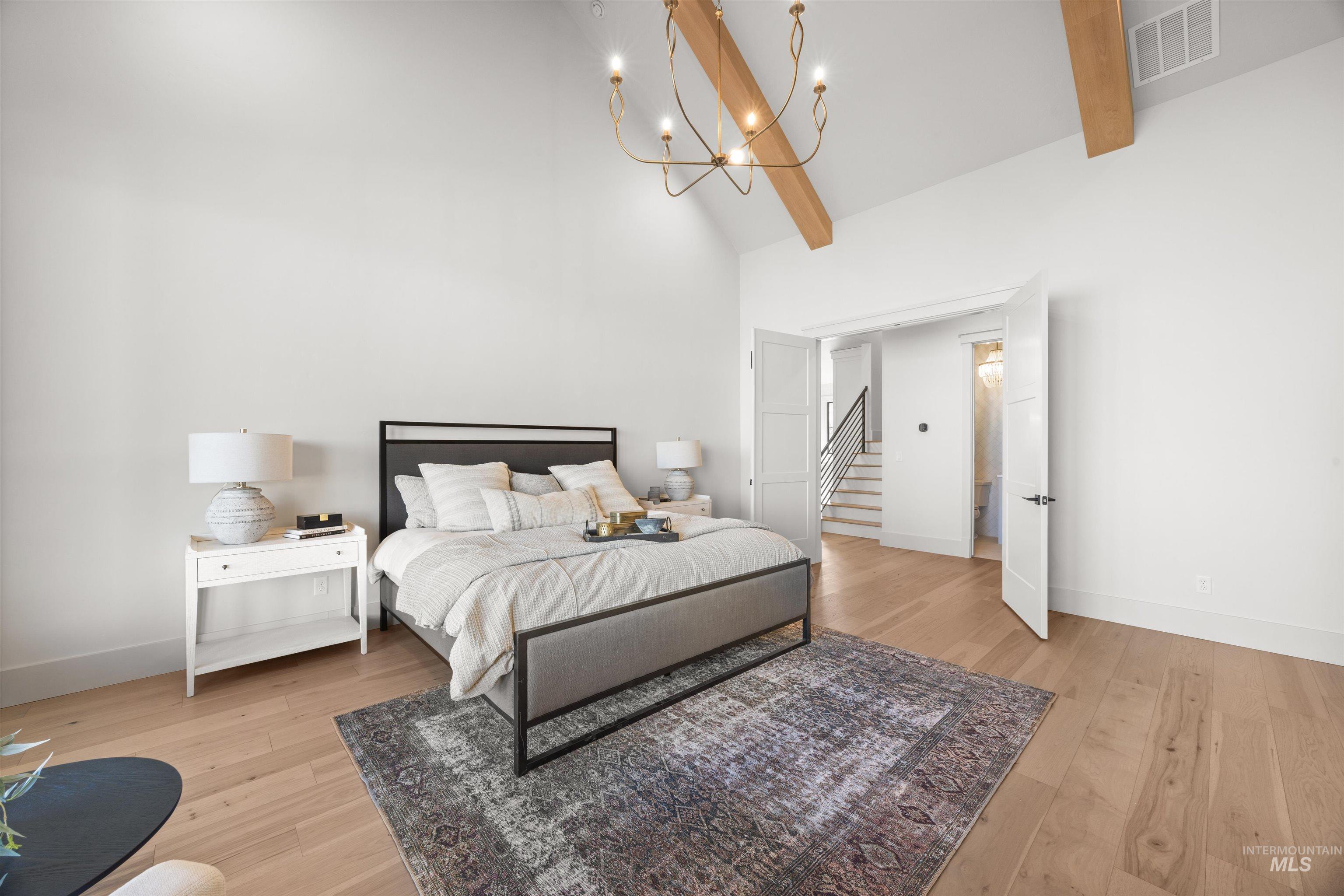 10968 North Elk Ridge Place Boise, ID 83714 - Photo 24 of 49 Bedroom featuring hanging lights, light wood finished floors, and vaulted ceiling