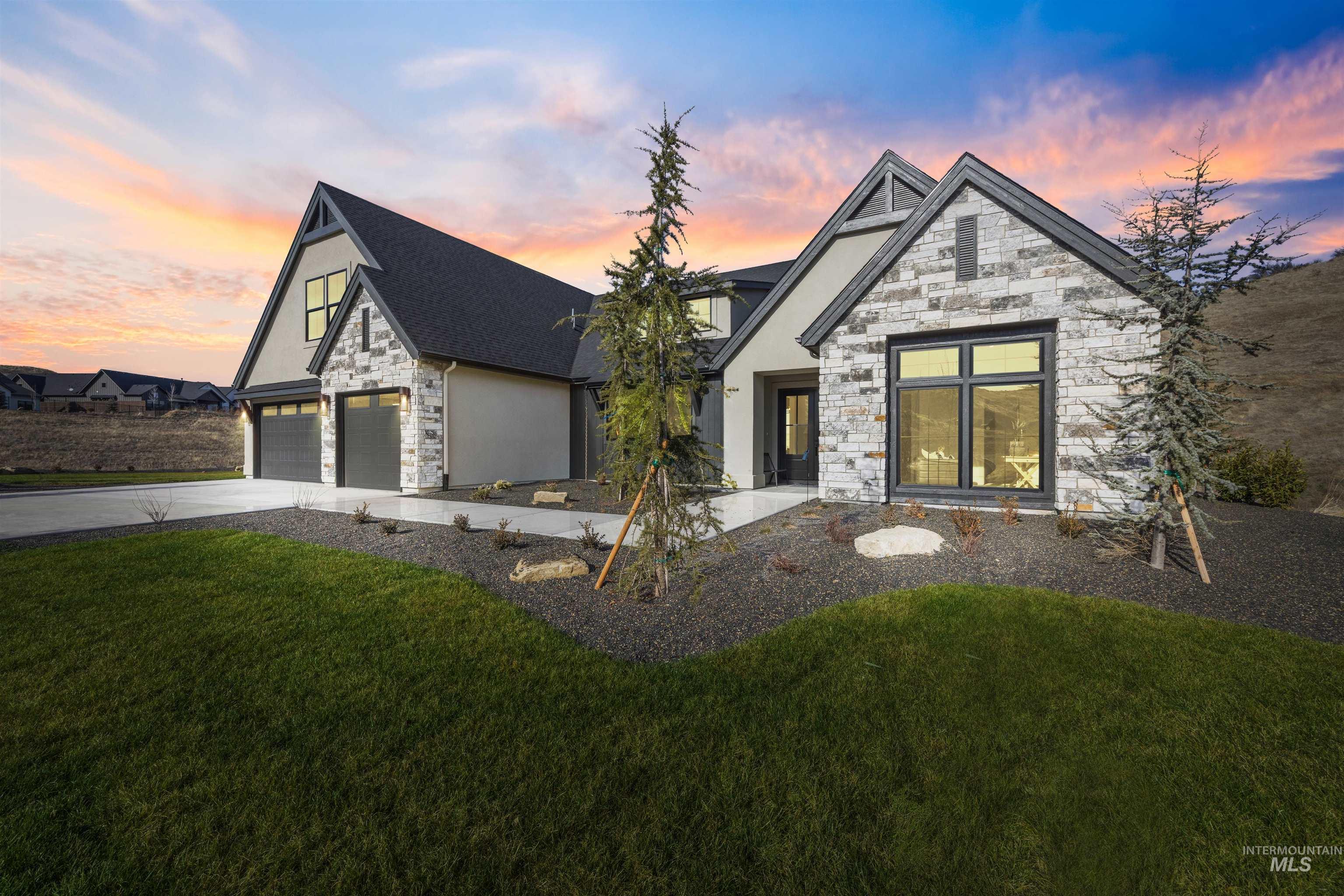 10968 North Elk Ridge Place Boise, ID 83714 - Photo 3 of 49 View of front facade with stone siding, stucco siding, driveway, and a yard