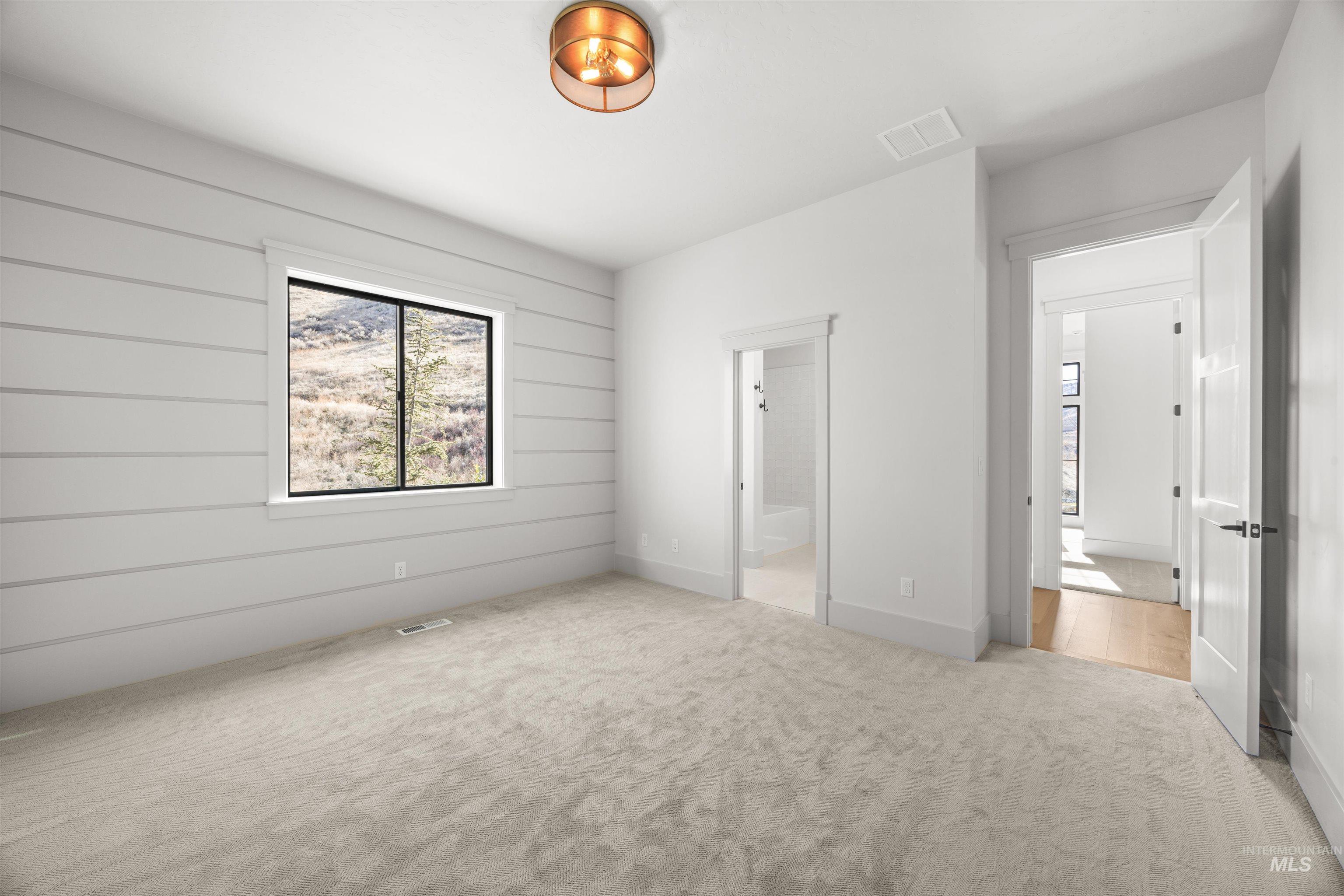 10968 North Elk Ridge Place Boise, ID 83714 - Photo 39 of 49 Unfurnished bedroom featuring light carpet and baseboards