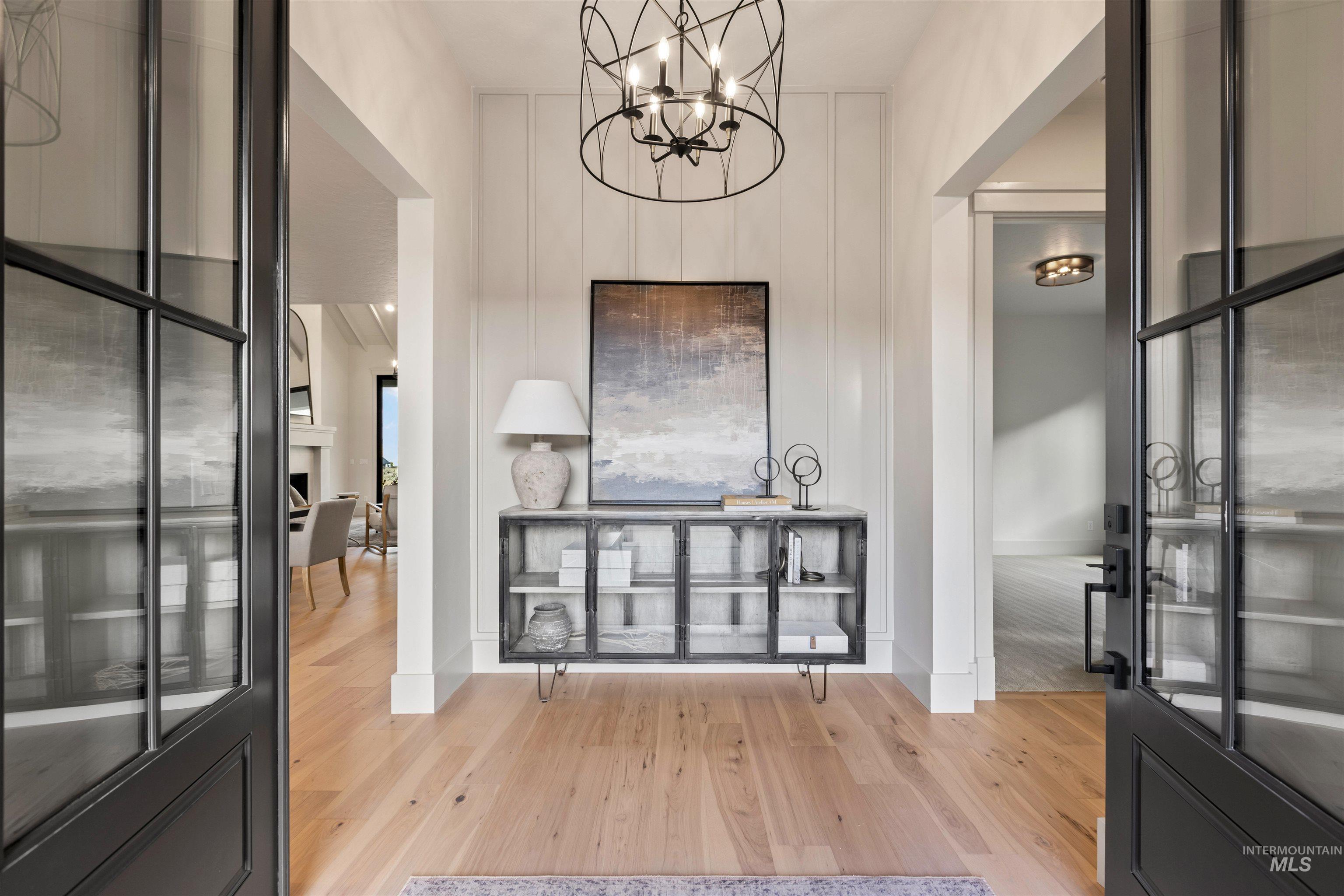 10968 North Elk Ridge Place Boise, ID 83714 - Photo 4 of 49 Foyer featuring light wood-type flooring and hanging lights