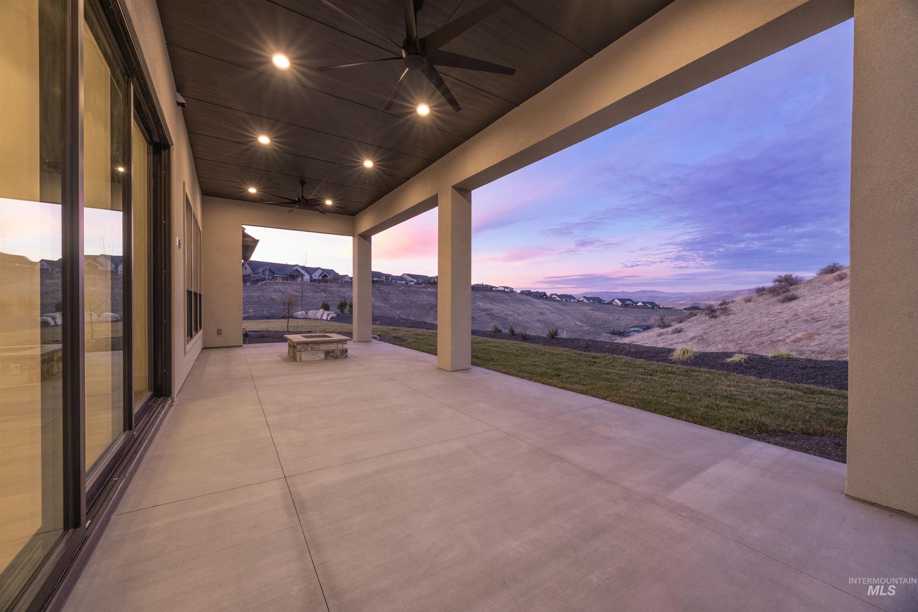 10968 North Elk Ridge Place Boise, ID 83714 - Photo 41 of 49 Patio terrace at dusk with a mountain view, a patio area, and a ceiling fan