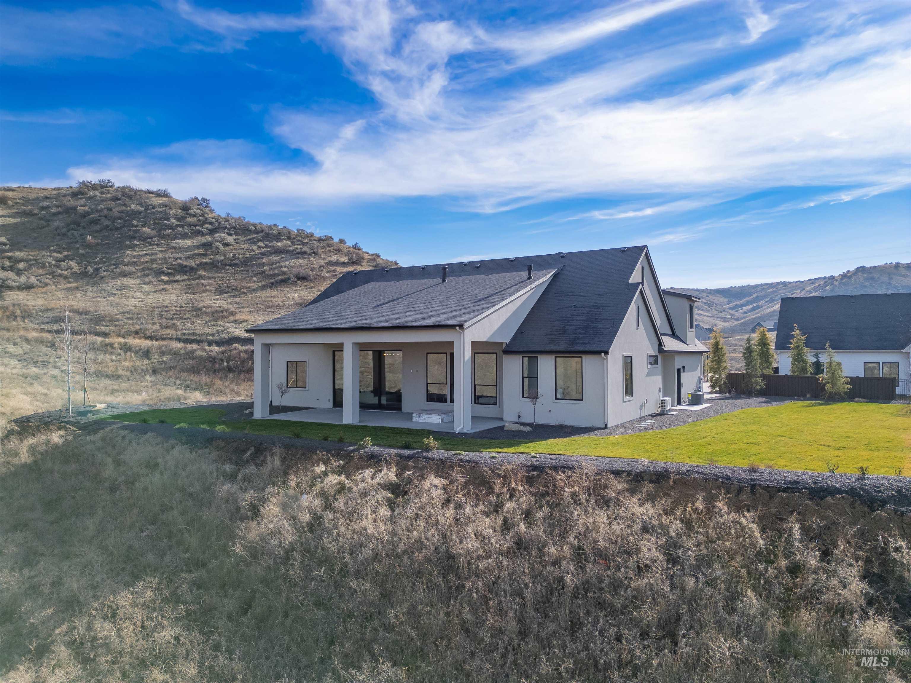 10968 North Elk Ridge Place Boise, ID 83714 - Photo 43 of 49 Rear view of property featuring a mountain view, a patio area, and stucco siding