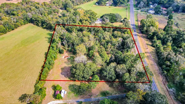 an aerial view of a houses with a yard
