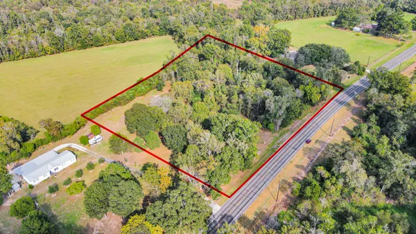 a view of a yard with wooden fence