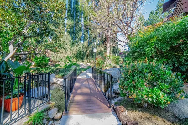 a view of a pathway with a wrought fence