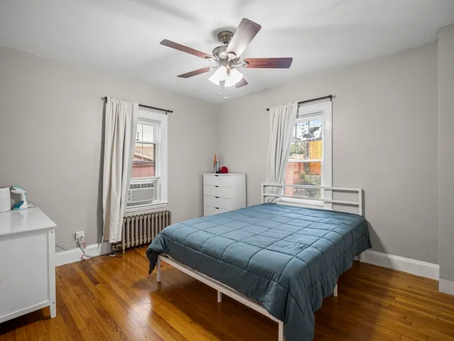 a bed sitting in a bedroom next to a window