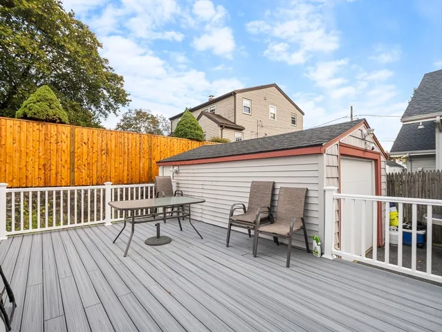 a view of a roof deck with wooden floor and fence
