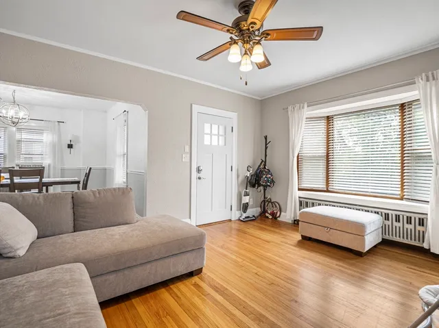 a spacious bedroom with a bed a couch and a large window