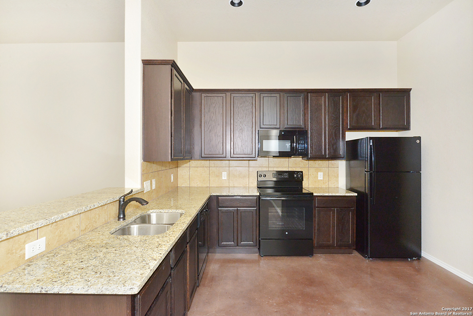 2557 Pahmeyer Road New Braunfels, TX 78130 - Photo 12 of 25 a kitchen with granite countertop a sink stove and refrigerator